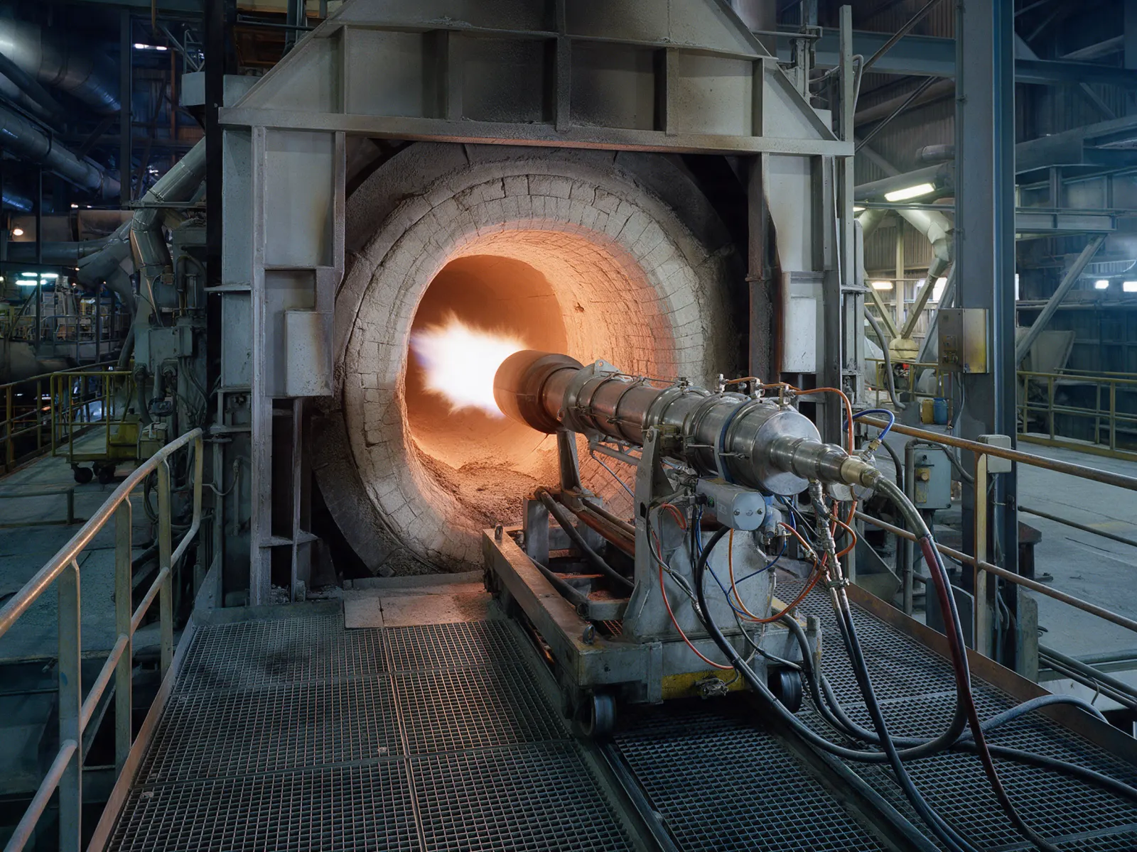 Multi-channel kiln burner entering the kiln hood